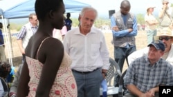 U.S Senators Bob Corker, center, and Chris Coons, right, speak with a South Sudanese refugee during a group discussion at the Bidi Bidi refugee settlement in northern Uganda, April 14, 2017.