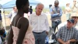 U.S Senators Bob Corker, center, and Chris Coons, right, speak with a South Sudanese refugee during a group discussion at the Bidi Bidi refugee settlement in northern Uganda, April 14, 2017.