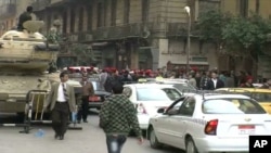 Police march through downtown Cairo, demanding better pay and respect, 14 February 2011