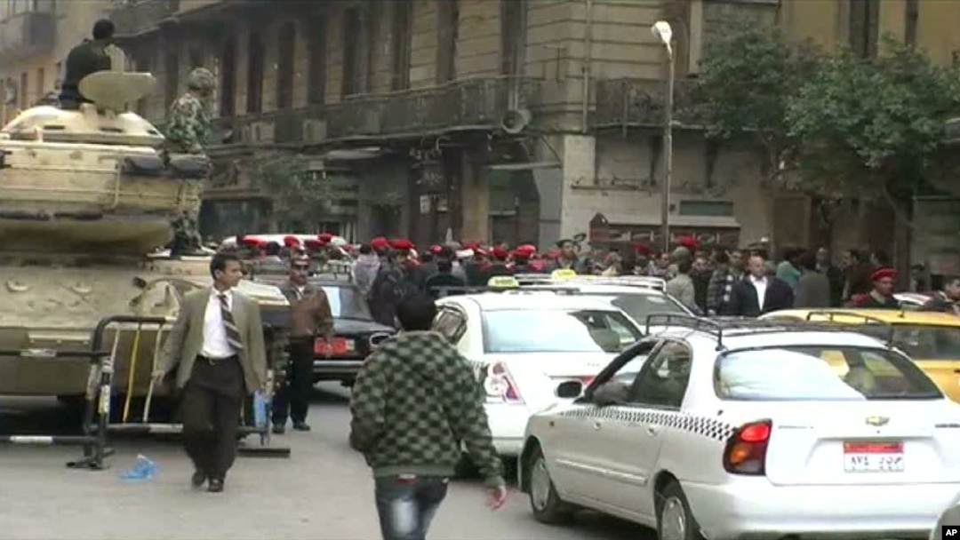 Police march through downtown Cairo, demanding better pay and respect, 14 February 2011