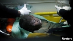 A child rescued from the rubble of a building that collapsed in a residential area receives medical attention inside an ambulance in Nairobi, Kenya, June 13, 2017.