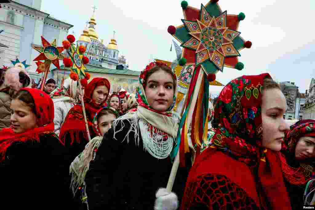 People wear traditional Ukrainian clothes as they mark Christmas Day with a carol singing event outside St. Michael&#39;s Golden-Domed Monastery in Kyiv, amid Russia&#39;s attack on Ukraine, Dec. 25, 2024.