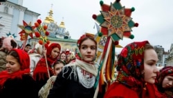 People wear traditional Ukrainian clothes as they mark Christmas Day with a carol singing event outside St. Michael's Golden-Domed Monastery, amid Russia's attack on Ukraine, in Kyiv, Ukraine, Dec. 25, 2024.