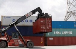 Containers of China Shipping and Cosco are loaded at a port in Ho Chi Minh City, Vietnam, July 27, 2018.