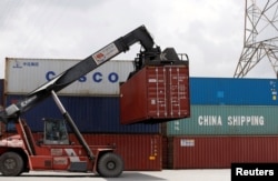 Containers of China Shipping and Cosco are loaded at a port in Ho Chi Minh City, Vietnam, July 27, 2018.