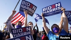 Supporters of Democratic U.S. presidential nominee Joe Biden celebrate near the site of his planned election victory celebration in Wilmington, Delaware.