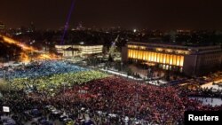 Protesters display the Romanian national flag colors during a demonstration in front of the government building in Bucharest, Romania, Feb. 12, 2017.