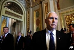 Vice President Mike Pence talks to reporters at the U.S. Capitol.