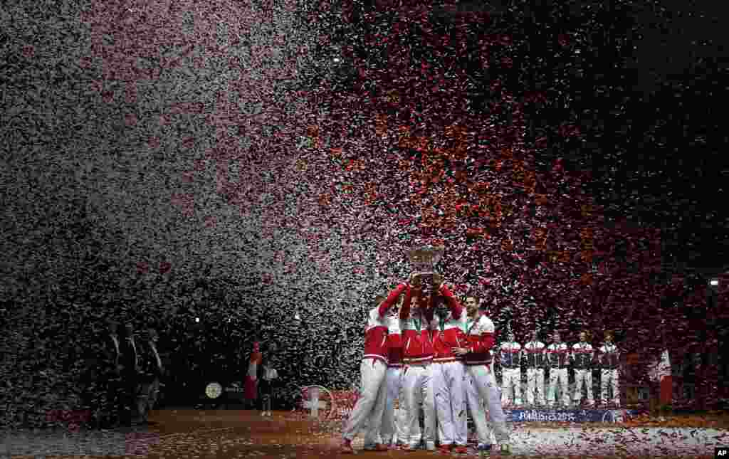 The Swiss team celebrates after defeating France in the Davis Cup final at the Pierre Mauroy stadium in Lille, northern France. Switzerland won 3-1 and wins the Davis Cup.