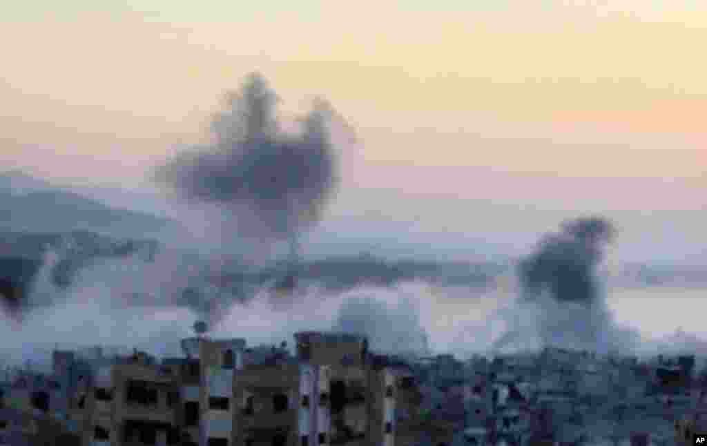 This image taken from video obtained from the Shaam News Network shows smoke rising from buildings after heavy artillery shelling in Barzeh, a district of Damascus, Sept. 10, 2013.