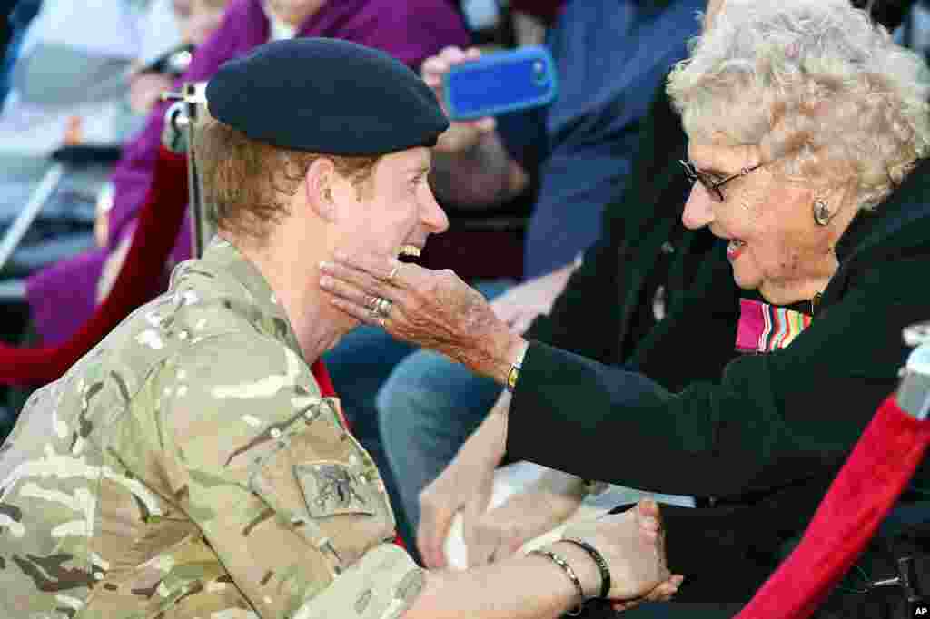 Britain's Prince Harry, left, talks with Australian war veteran Daphne Dunne during a visit to the Sydney Opera House in Sydney.