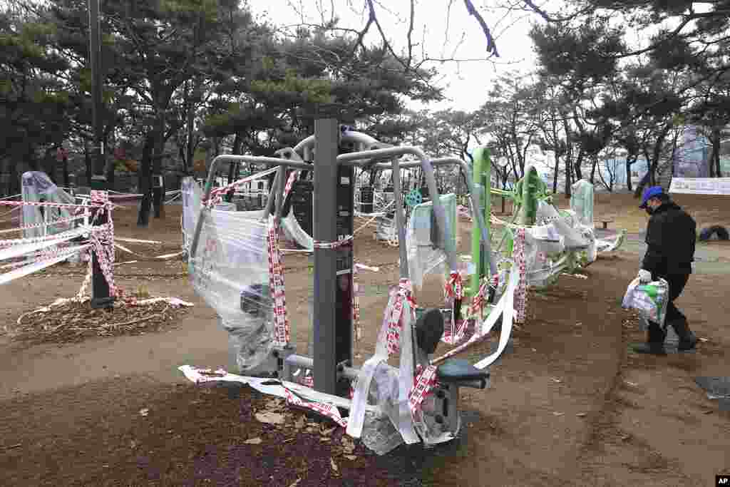 Exercise equipment is covered up, as the use of public sports facilities is banned amid social distancing rules at a park in Goyang, South Korea.