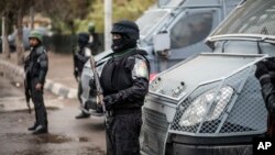 FILE - Policemen stand guard on the anniversary of the 2011 uprising in Tahrir Square in the Haram district of Cairo, Egypt, Jan. 25, 2016. Thirteen policemen were sentenced to prison for taking part in a 2015 strike for better pay and working conditions.