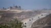 Iring-iringan mobil militer Israel meninggalkan Jalur Gaza tampak dari bagian selatan Israel, Rabu, 12 Juni 2024. (Foto: Tsafrir Abayov)
