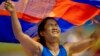 Cambodia's Chov Sotheara celebrates her victory over Thailand's Suree Porn Pimpak to win the gold medal in the women's under 44-kilogram wrestling match at South East Asian Games in Yangon, Myanmar, Friday, Dec 13, 2013. (AP Photo/Gemunu Amarasinghe)