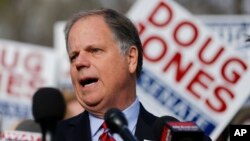 Democratic candidate for U.S. Senate Doug Jones speaks to reporters after casting his ballot, Dec. 12, 2017, in Mountain Brook, Alabama.