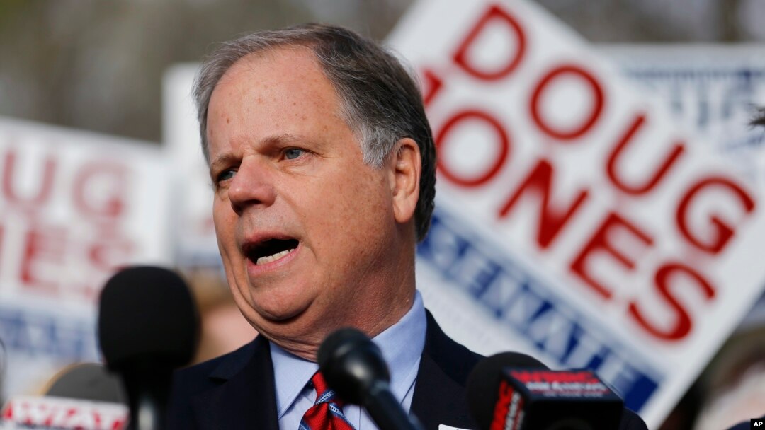 Democratic candidate for U.S. Senate Doug Jones speaks to reporters after casting his ballot, Dec. 12, 2017, in Mountain Brook, Alabama.