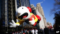 FILE: Greg Heffley from the "Diary of a Wimpy Kid" series balloon passes by windows of a building on Central Park West during the 92nd annual Macy's Thanksgiving Day Parade in New York. Taken Thurs. Nov. 22, 2018.