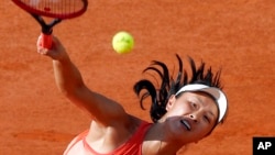 FILE - China's Peng Shuai returns France's Caroline Garcia during French Open second round match at Roland Garros stadium, Paris, May 31, 2018.