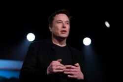 FILE - Tesla CEO Elon Musk speaks at the company's design studio in Hawthorne, California, March 14, 2019.