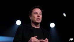FILE - Tesla CEO Elon Musk speaks before unveiling the Model Y at the company's design studio in Hawthorne, California, March 14, 2019.