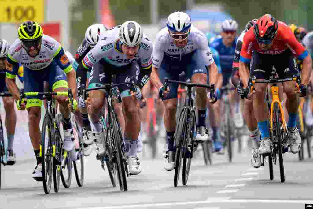 Peter Sagan of Slovakia (2nd L) sprints to win, at the arrival of the stage 2 (168.1 kilometers from Aigle to Martigny), during the Tour de Romandie UCI World Tour 2021 cycling race in Martigny, Switzerland.