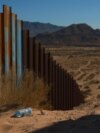 A plastic bottle lies in the sand near the border wall on the US-Mexico border, as seen from Ciudad Juarez, Mexico Oct. 23, 2024.