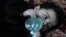 Baby Sohail Ahmadi drinks milk from a bottle inside the house of Hamid Safi, a taxi driver who found Sohail in the airport, in Kabul, Afghanistan, Jan. 7, 2022.
