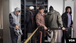 Ahmadi worshippers collect their shoes and belongings after prayer at Masjid Bait Ul Tahir, in Brooklyn. (R. Taylor/VOA)