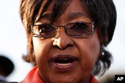FILE - Winnie Madikizela-Mandela addresses journalists in front of the house of her former husband and former South African President Nelson Mandela in Soweto, June 28, 2013.