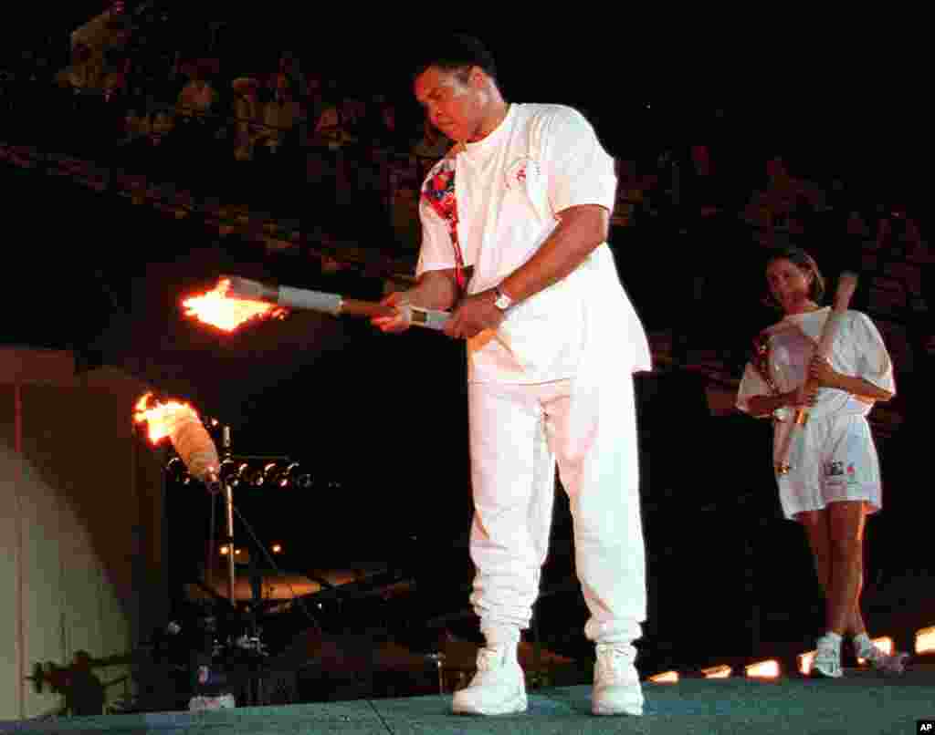 In this July 19, 1996, file photo, Muhammad Ali lights the Olympic flame during the 1996 Summer Olympic Games opening ceremony in Atlanta.