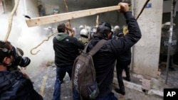 Farmers clash with riot police during a protest outside Agriculture ministry in Athens, Feb. 12, 2016.