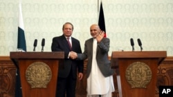 FILE - Afghan President Ashraf Ghani, right, shakes hands with Pakistani Prime Minster Nawaz Sharif during a joint press conference at the presidential palace in Kabul, Afghanistan, May 12, 2015. 