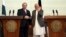 Afghan President Ashraf Ghani, right, shakes hands with Pakistani Prime Minster Nawaz Sharif during a joint press conference at the presidential palace in Kabul, May 12, 2015. 