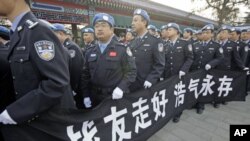 Members of China's peacekeeping police contingent, who have been to Haiti, hold a banner as they wait in line to attend a funeral for eight Chinese peacekeepers killed in the Haiti earthquake, at Babaoshan Revolutionary Cemetery in Beijing, January 20, 20