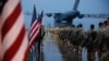 US Army paratroopers prepare equipment and load aircraft at Fort Bragg, N.C. on Jan. 4, 2020. This Pentagon said their deployment is a response to increased threats against US personnel and facilities.