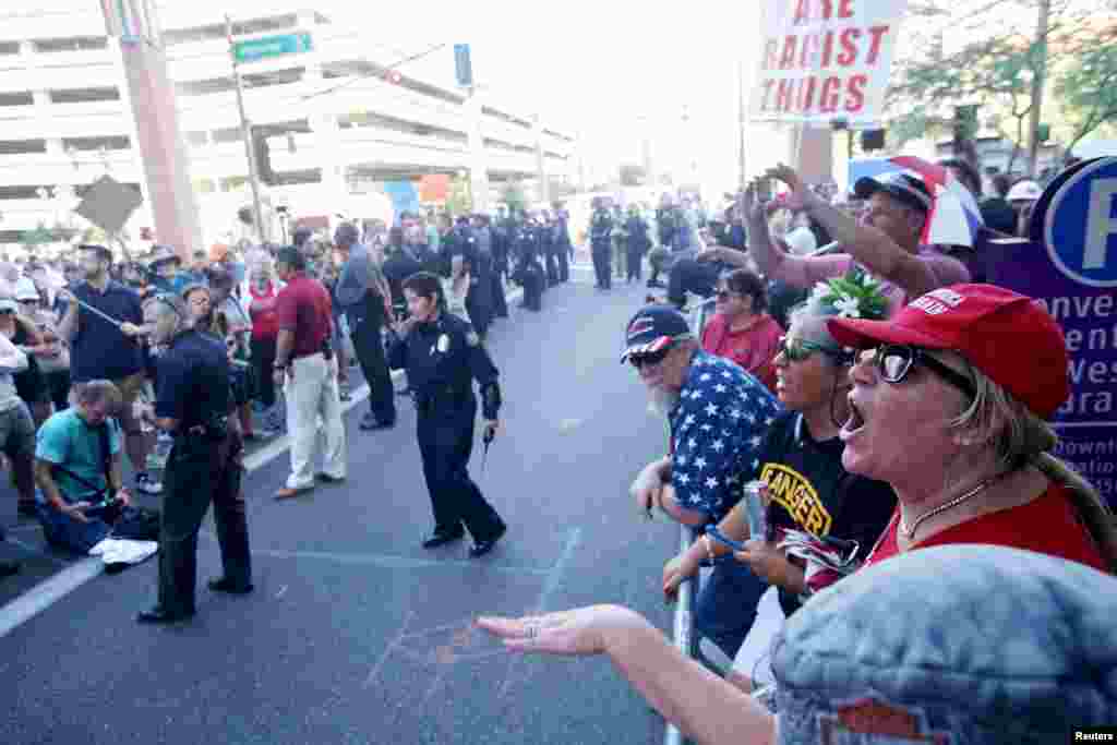 Pro Trump supporters face off with peace activists during protests outside a Donald Trump campaign rally in Phoenix, Ariz., Aug. 22, 2017.