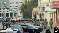 Saudi riot police gather as Saudi Shi'ite protesters, unseen, chant slogans during a demonstration in Qatif, March 11, 2011