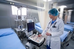 FILE - A medical worker sets up medical equipment in the Central Clinical Hospital "Russian Railways Medicine", redesigned to receive patients with coronavirus in Moscow, April 3, 2020.
