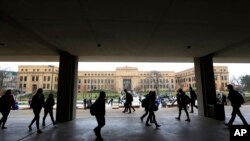 FILE - Students walk between classes at the University of Kansas in Lawrence, Kan.