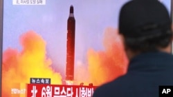 FILE - A man watches a TV news program, Oct. 16, 2016, showing a file image of a missile launch conducted by North Korea.