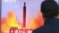 FILE - A man watches a TV news program, Oct. 16, 2016, showing a file image of a missile launch conducted by North Korea.