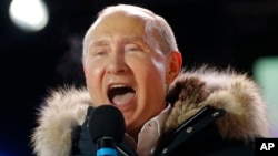 Russian President Vladimir Putin speaks to supporters during a rally near the Kremlin in Moscow, March 18, 2018.