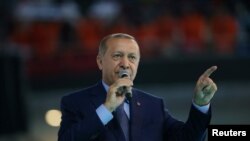 Turkish President Tayyip Erdogan makes a speech during a meeting of his ruling AK Party in Ankara, Turkey August 4, 2018. 