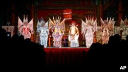 Cantonese opera actors perform inside a bamboo theater in Kowloon District, Hong Kong Friday, Jan. 20, 2012. 