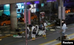 Forensic experts work outside Istanbul Ataturk Airport, Turkey, following explosions, June 28, 2016.