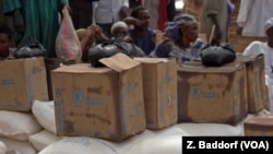 FILE - Humanitarian workers distribute food at an internally displaced persons camp in Bambari, Central African Republic, Jan. 2017.