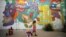 A girl looks at a wall painting by Israeli artist who goes by the name Dioz, during an art happening, called POW! WOW! Israel, which is connected to a week-long art and culture festival held in Hawaii called POW! WOW! Hawaii, in the southern city of Arad,