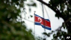 FILE - The North Korean flag flies above the North Korean Embassy in Beijing, April 20, 2017. The South Korean news agency says North Korea has detained a third U.S. citizen.