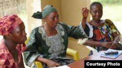 FILE - Ebola survivors, such as these women in Sierra Leone, report persistent health issues such as impaired vision and severe chronic pain. (Photo courtesy of WHO/S. Gborie) 